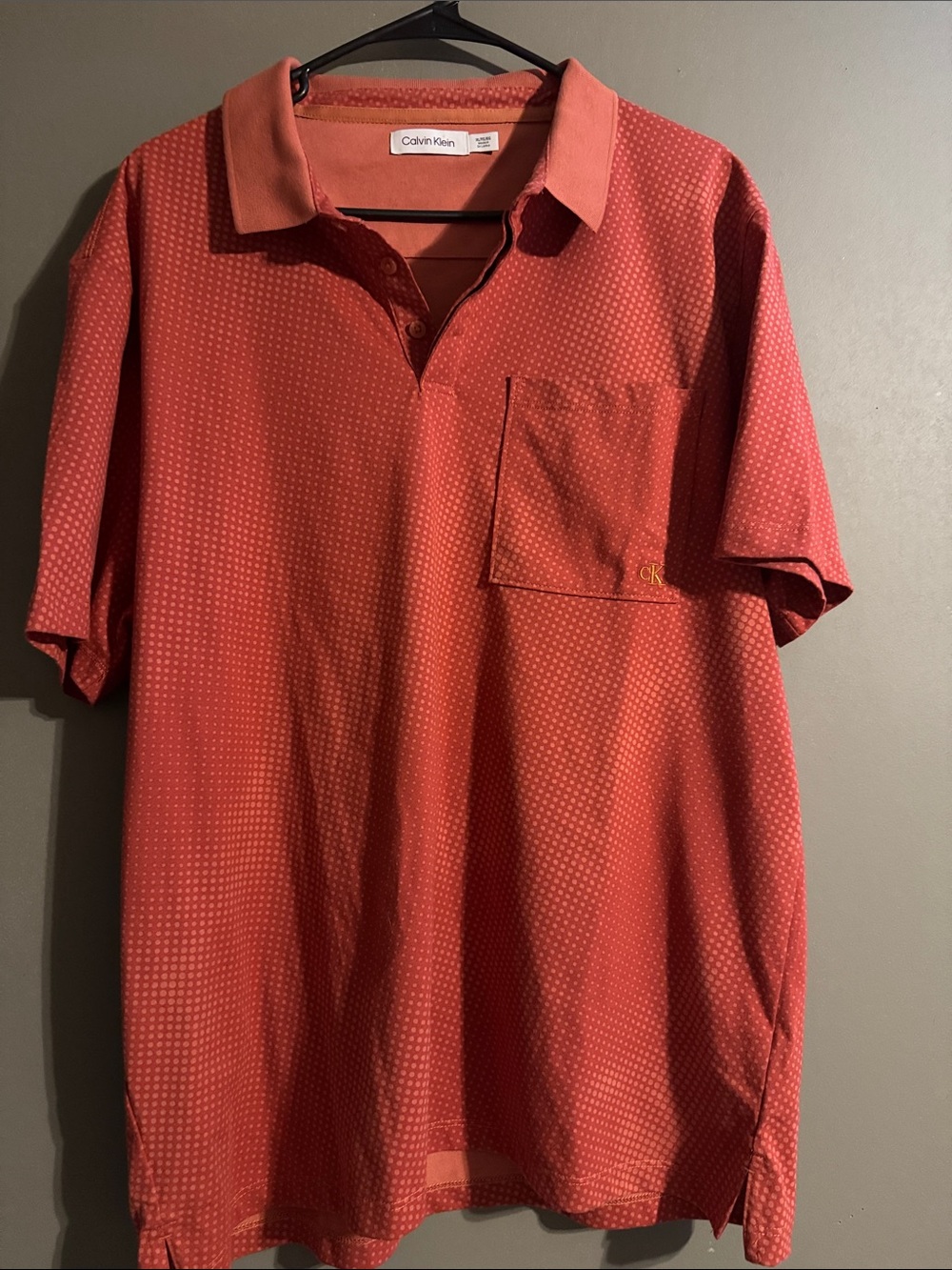 Calvin Klein Men's Coral-Red Polo with Subtle Dot Pattern